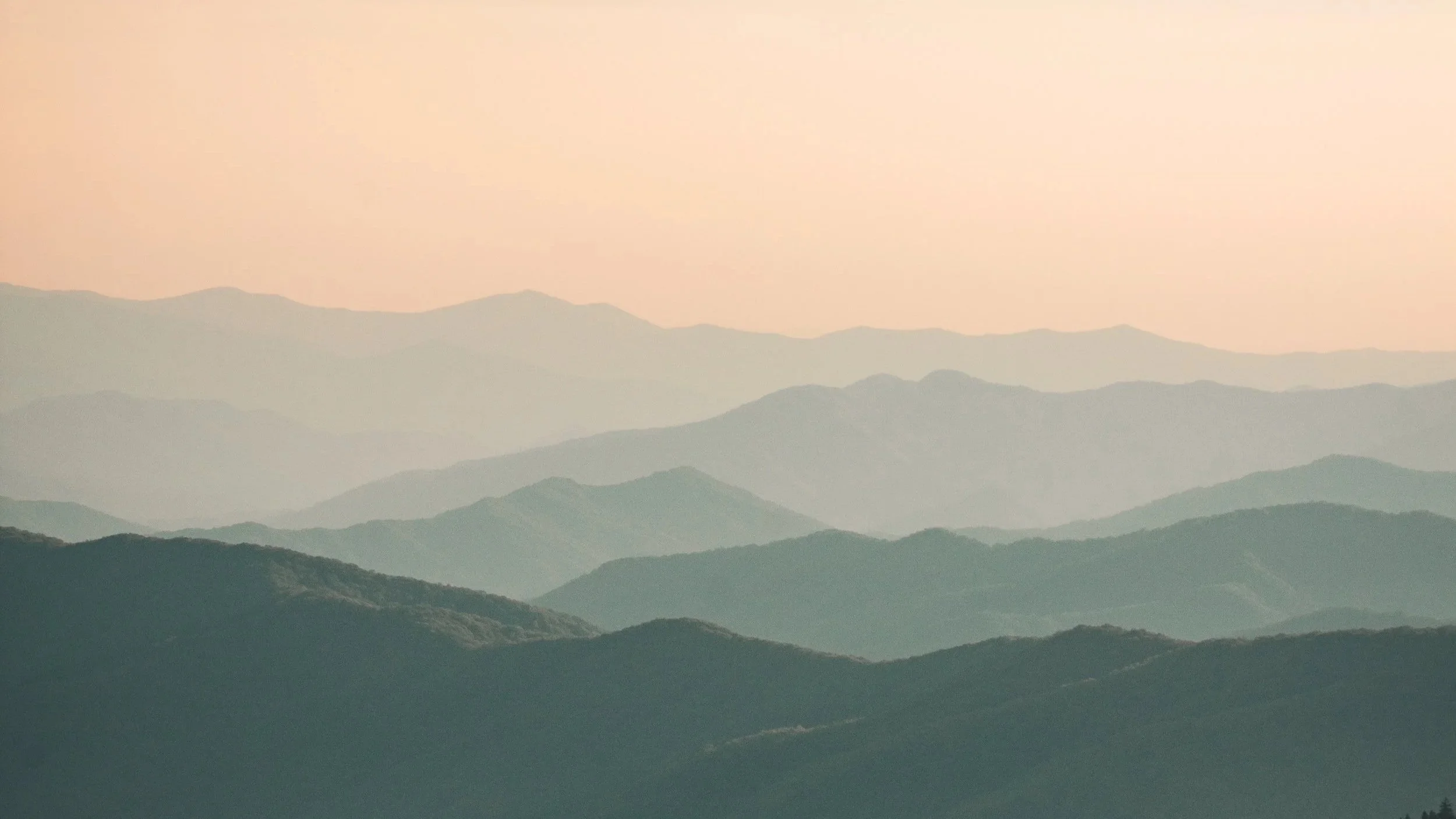 Misty mountain landscape at dusk — evoking calm and contemplation